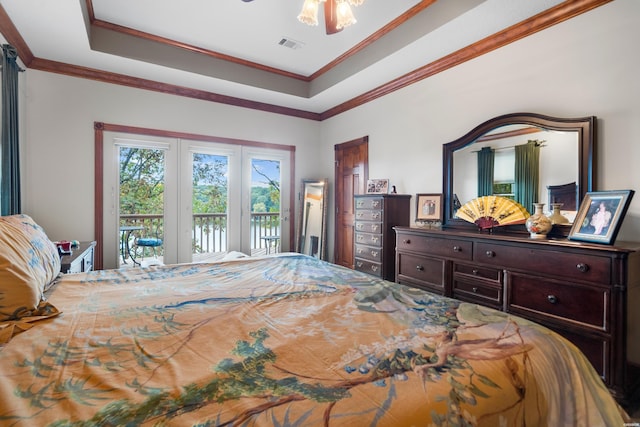 bedroom with access to outside, visible vents, a raised ceiling, and crown molding