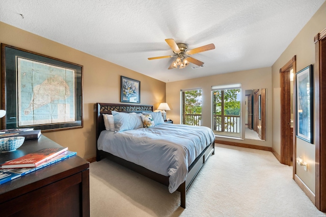 bedroom featuring baseboards, a ceiling fan, light colored carpet, access to outside, and a textured ceiling