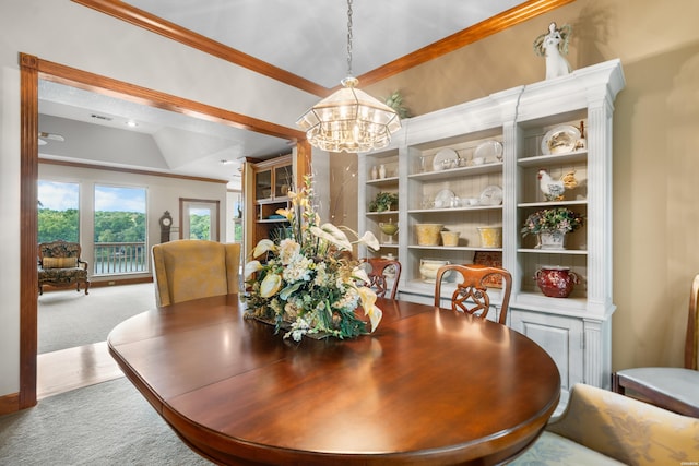 carpeted dining area featuring a notable chandelier, visible vents, and crown molding