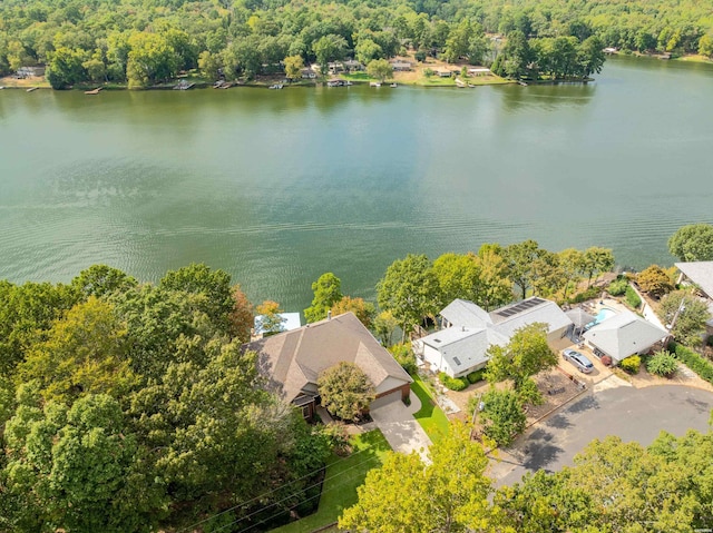 birds eye view of property with a water view and a wooded view