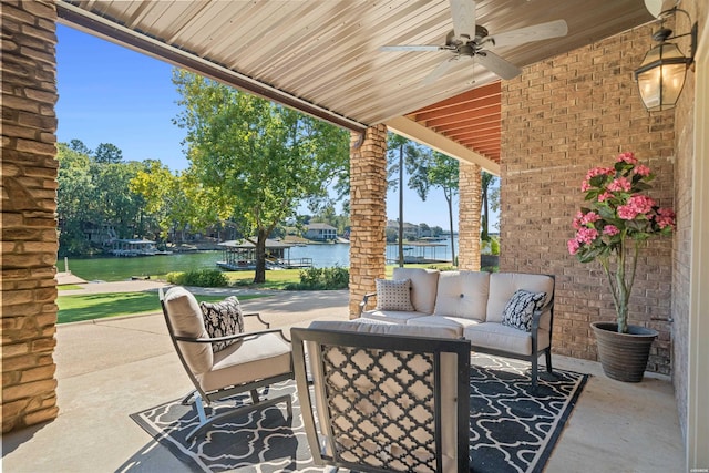 view of patio featuring a water view, an outdoor living space, and a ceiling fan