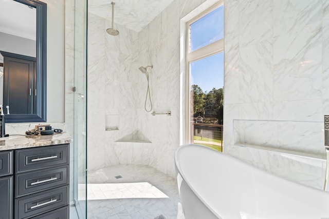 full bath with a soaking tub, a marble finish shower, ornamental molding, and vanity