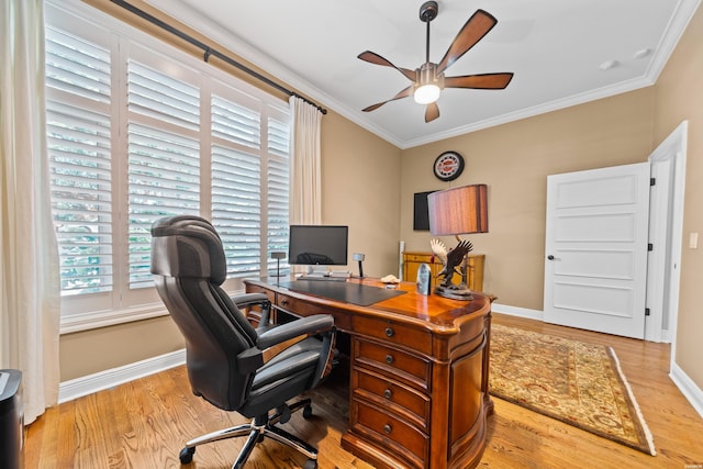 office area featuring baseboards, crown molding, and light wood finished floors