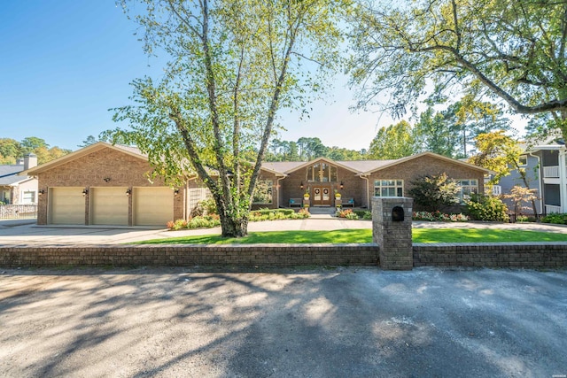 view of front of house with concrete driveway, brick siding, and an attached garage