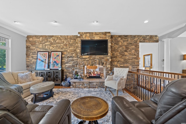 living room featuring ornate columns and crown molding