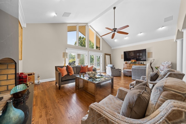 living area with ceiling fan, high vaulted ceiling, wood finished floors, visible vents, and baseboards