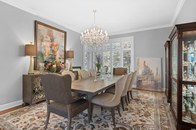 dining space featuring baseboards, light wood-type flooring, an inviting chandelier, and crown molding