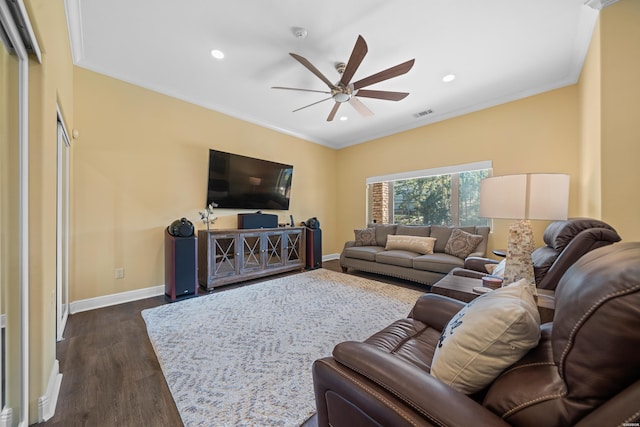 living room featuring ornamental molding, dark wood-style flooring, ceiling fan, and baseboards