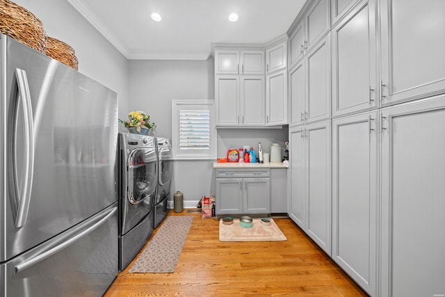 kitchen featuring separate washer and dryer, light countertops, gray cabinets, freestanding refrigerator, and crown molding