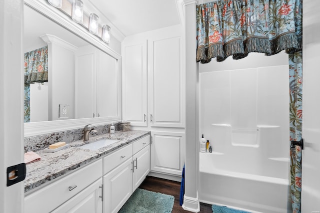 bathroom featuring shower / bathtub combination with curtain, wood finished floors, and vanity