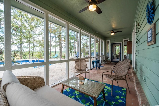 sunroom / solarium featuring ceiling fan