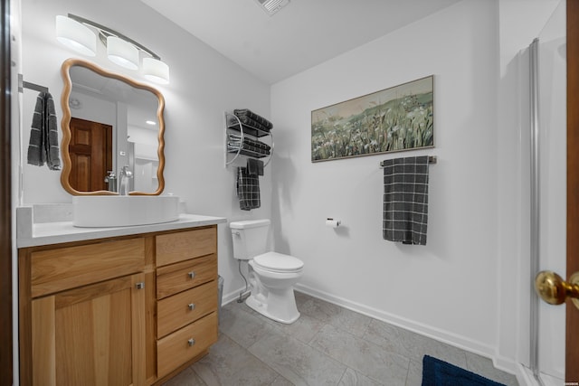 bathroom with visible vents, vanity, toilet, and baseboards