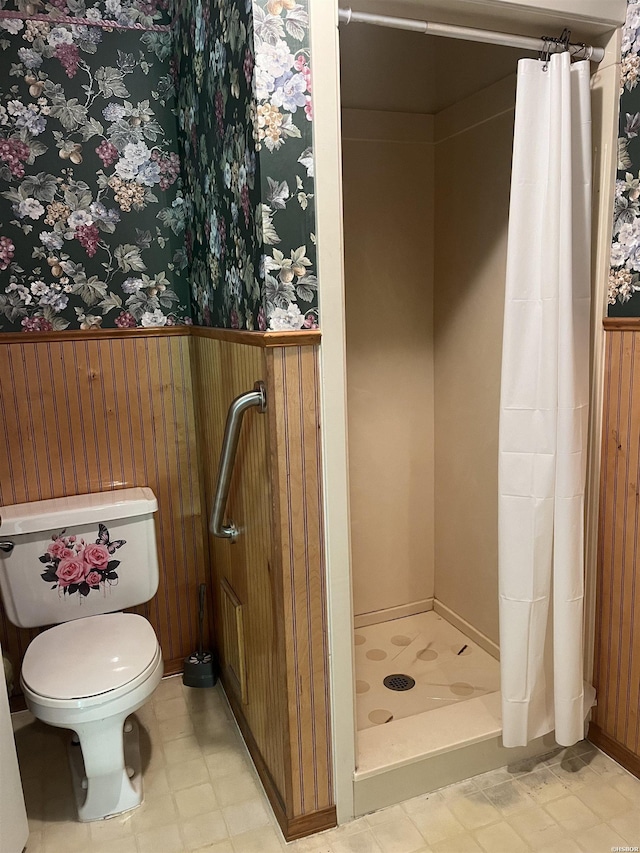 811 N 1st St, Glenwood, AR 71943 - bathroom featuring a shower stall, wallpapered walls, tile patterned floors, and a wainscoted wall