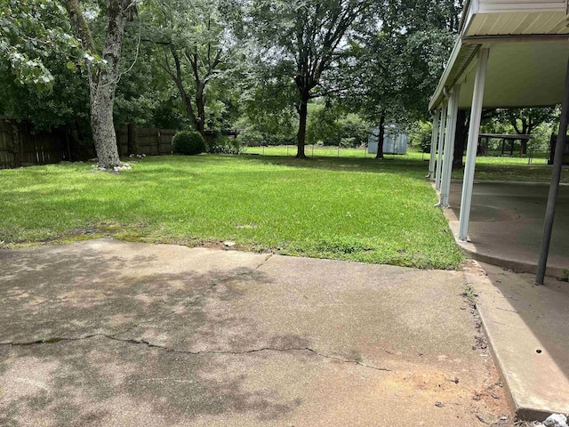 811 N 1st St, Glenwood, AR 71943 - view of yard with a patio, view of wooded area, and a shed
