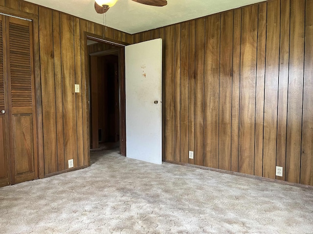 811 N 1st St, Glenwood, AR 71943 - carpeted empty room with wooden walls and a ceiling fan