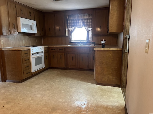 811 N 1st St, Glenwood, AR 71943 - kitchen with white appliances, light floors, light countertops, and decorative backsplash