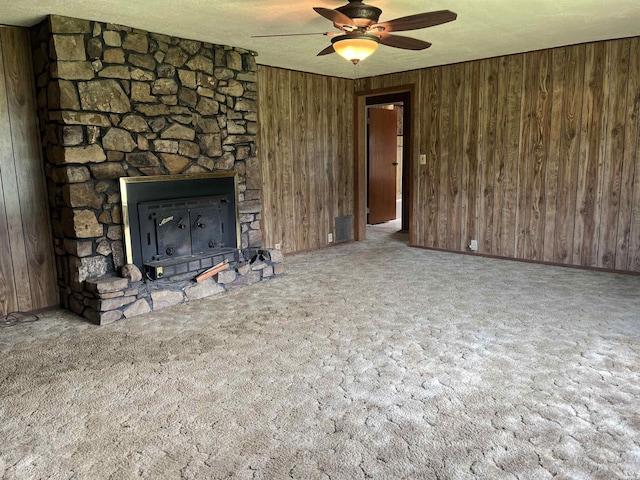 811 N 1st St, Glenwood, AR 71943 - unfurnished living room with carpet flooring, a ceiling fan, wooden walls, and a textured ceiling