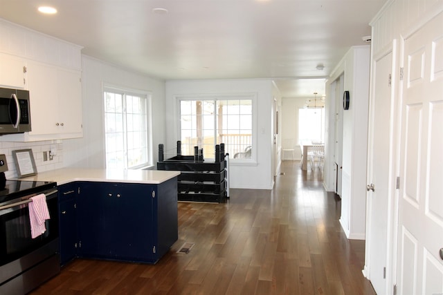 189 Bayshore Cv, Hot Springs, AR 71913 - kitchen featuring dark wood-style floors, appliances with stainless steel finishes, light countertops, blue cabinetry, and white cabinetry