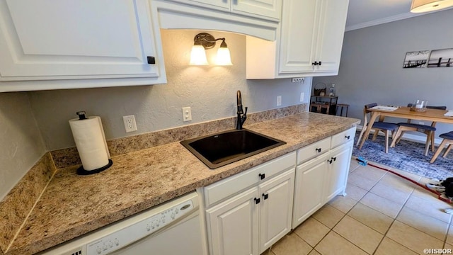 kitchen with white dishwasher, a sink, white cabinets, light countertops, and ornamental molding