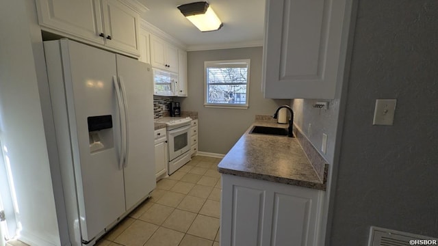 kitchen with crown molding, light tile patterned floors, white cabinets, a sink, and white appliances