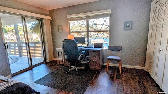 office space with wood finished floors and baseboards