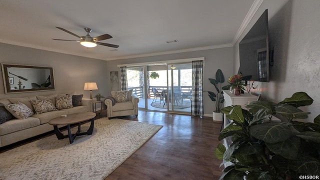 living area with crown molding, visible vents, a ceiling fan, wood finished floors, and baseboards