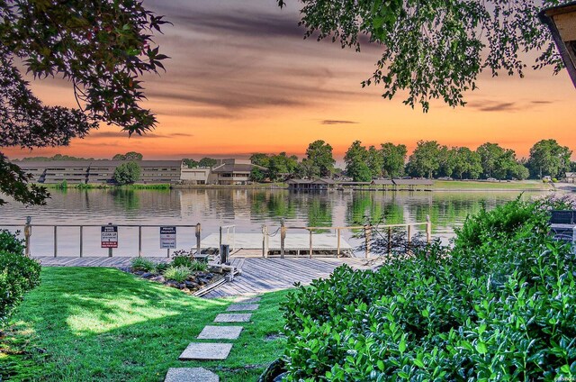 dock area featuring a water view and a yard