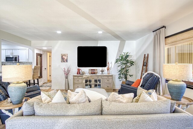 living room with recessed lighting and baseboards