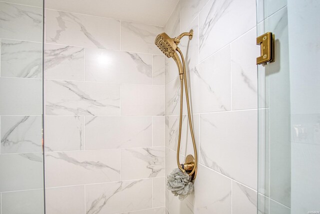 bathroom with a tile shower