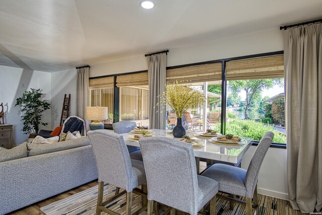 dining area featuring wood finished floors and recessed lighting