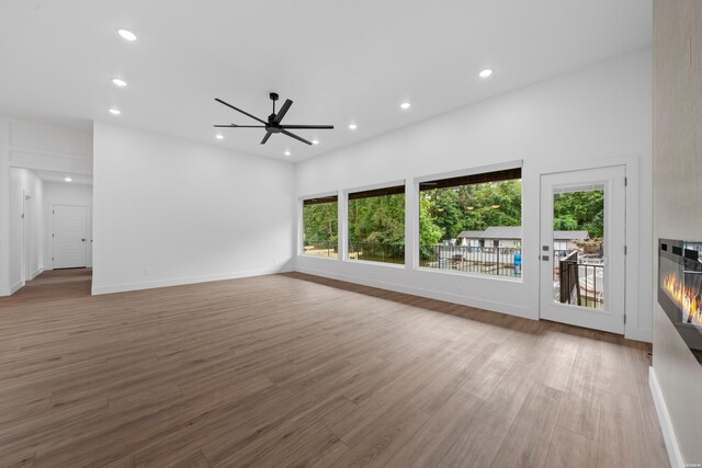 168 Krause Ln Unit B, Hot Springs, AR 71913 - unfurnished living room with healthy amount of natural light, recessed lighting, a glass covered fireplace, ceiling fan, and wood finished floors