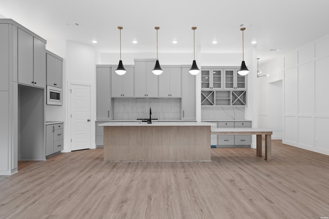 168 Krause Ln Unit B, Hot Springs, AR 71913 - kitchen with gray cabinets, built in microwave, light wood finished floors, tasteful backsplash, and light countertops