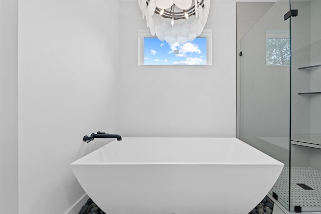 168 Krause Ln Unit B, Hot Springs, AR 71913 - full bathroom featuring a chandelier, a freestanding tub, a stall shower, and baseboards