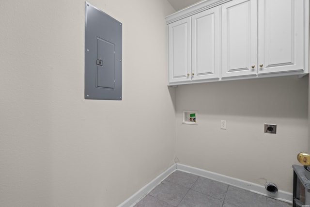 laundry room with hookup for an electric dryer, baseboards, cabinet space, tile patterned floors, and electric panel