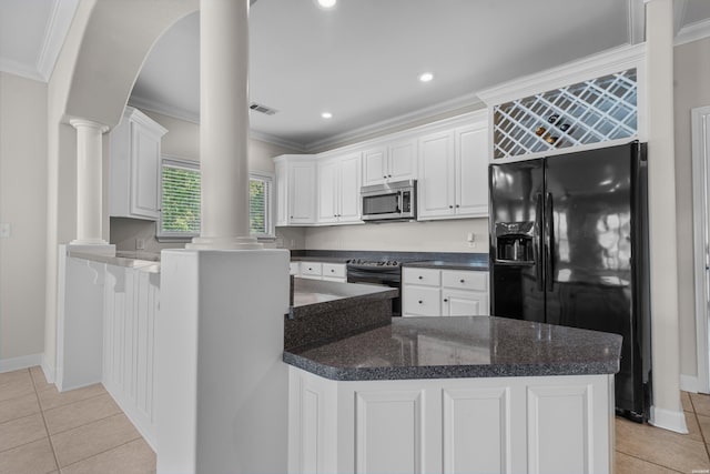 kitchen with range with electric stovetop, white cabinets, black fridge, stainless steel microwave, and decorative columns