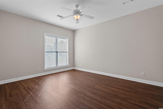 unfurnished room featuring a ceiling fan, visible vents, baseboards, and dark wood-style floors