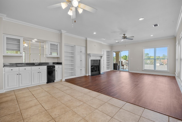 kitchen featuring dark countertops, open floor plan, white cabinetry, and light tile patterned floors