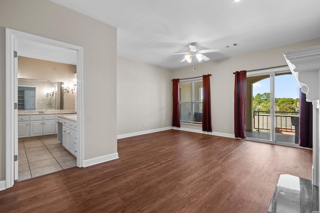 interior space with light wood-style floors, ceiling fan, visible vents, and baseboards