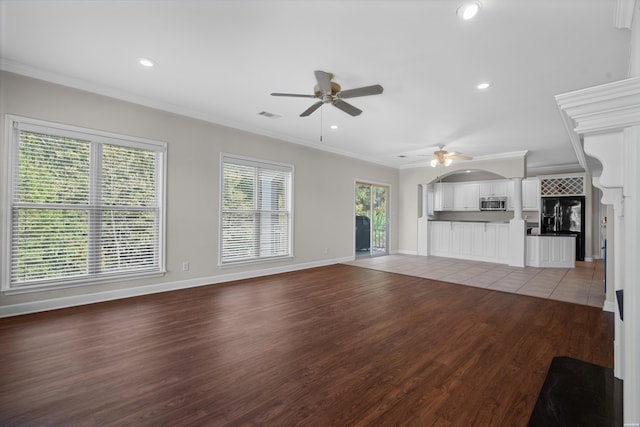 unfurnished living room with ceiling fan, recessed lighting, baseboards, ornamental molding, and light wood finished floors