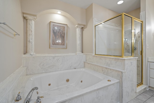 full bath with a whirlpool tub, tile patterned flooring, a shower stall, and decorative columns