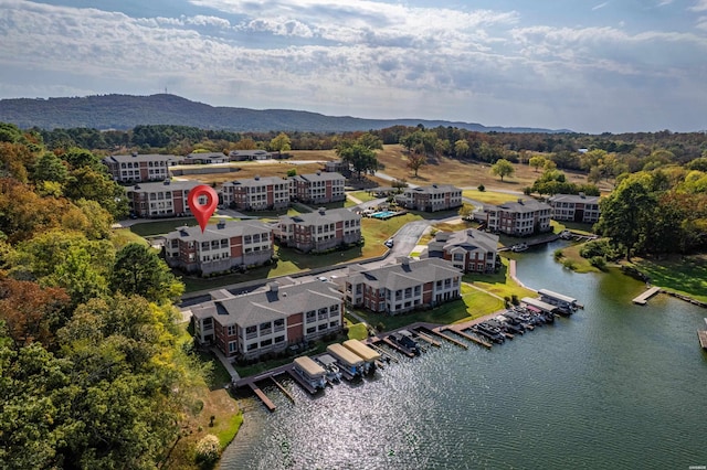 birds eye view of property with a water and mountain view