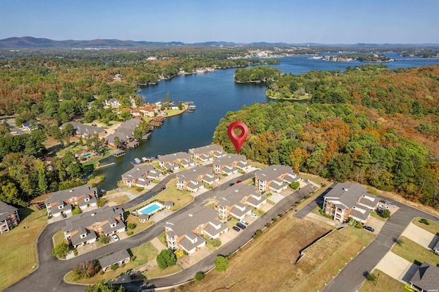 aerial view with a water view, a wooded view, and a residential view