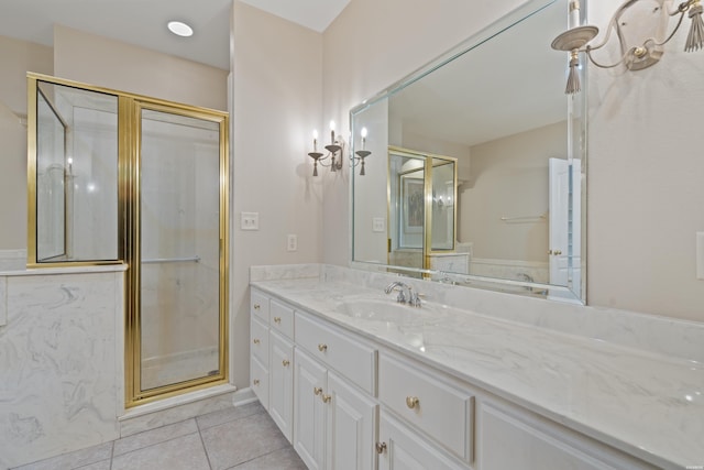 bathroom featuring tile patterned flooring, vanity, and a shower stall