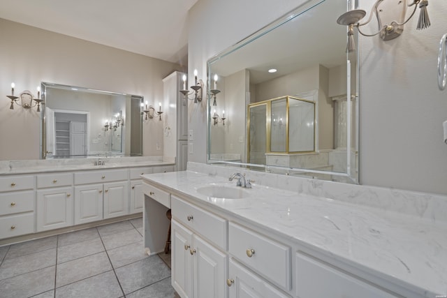 bathroom with two vanities, a stall shower, tile patterned flooring, and a sink