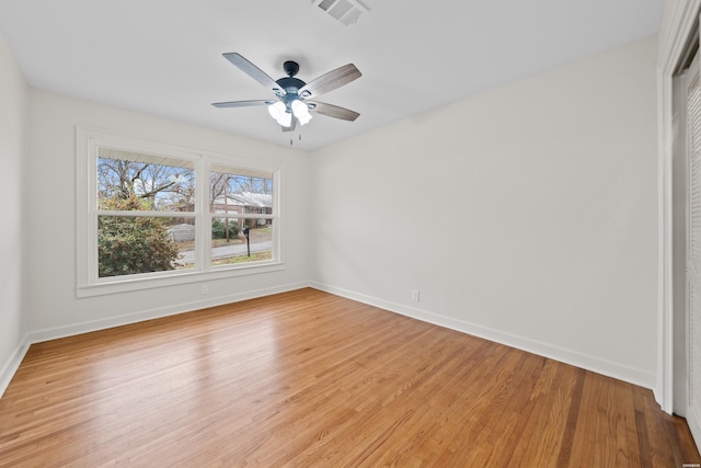 empty room featuring light wood-style flooring, baseboards, and visible vents
