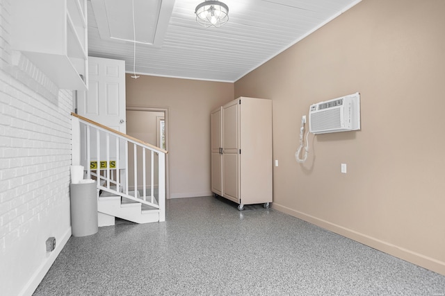 interior space with baseboards and a wall mounted air conditioner