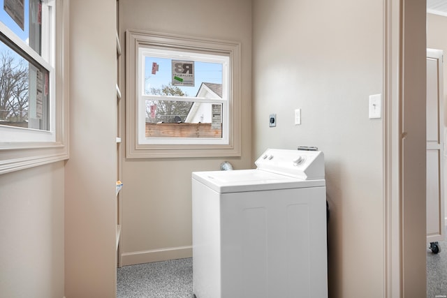 washroom with laundry area, washer / dryer, and baseboards