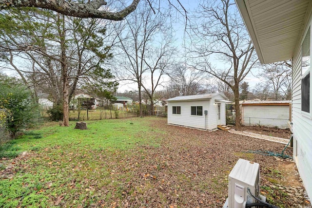 view of yard with an outbuilding and fence