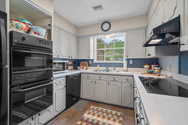 206 Shawnee St, Hot Springs, AR 71901 - kitchen featuring under cabinet range hood, a sink, black appliances, decorative backsplash, and light countertops