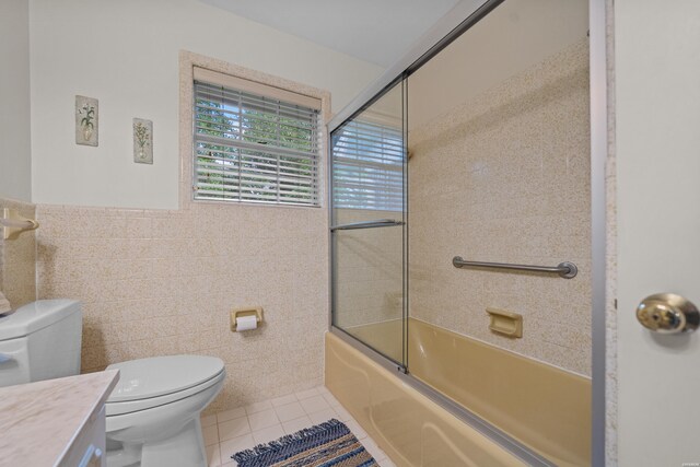 206 Shawnee St, Hot Springs, AR 71901 - bathroom with tile walls, tile patterned floors, toilet, vanity, and enclosed tub / shower combo